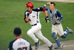 Kitsap County All-Stars coach Dan Zuber watches as All-Stars player Dylan Zubar rushes back to third base after trying to steal home during the fourth game of the 13-year-old Babe Ruth World Series