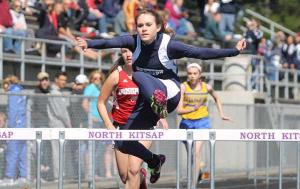 Pe Ell's Alissa Brooks-Johnson jumps over the final hurdle during the first heat of the 100 meter hurdles at the Lil' Norway Invite April 14 at the North Kitsap High School Stadium.
