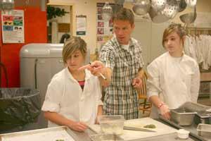 Culinary arts instructor Aaron Covey helps sophomores Ashley Beaudet and Megan Helsley prepare ingredients for the morning prep list on Oct.5 at the Odin Inn. The Inn is part of the career and technical education program at North Kitsap High School.