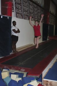 Olympic Gymnastics Center teacher Shawn Ellison watches a young gymnast practice. The facility has become an option for Central Kitsap and Bremerton gymnasts who aren’t offered the sport in each of the school districts.