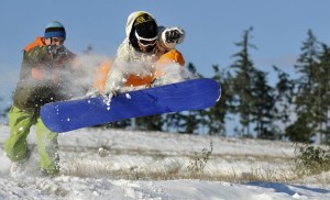 Sky Hardesty launches his snowboard off a ledge near Olhava Way in Poulsbo Tuesday
