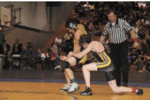 Knight Cody King (right) muscles a Hudson’s Bay wrestler during the regional championships. King is a state alternate.