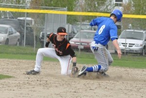Central Kitsap High School senior Tyler Baumgartner applies a tag to Olympic High School outfielder Blake Johnson during Olympic’s 9-2 victory over the Cougars Saturday at Gene Lobe Field at the Kitsap County Fairgrounds.