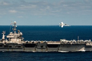 An F/A-18E Super Hornet assigned to the Warhawks of Strike Fighter Squadron 97 performs a flyby during an aerial change of command ceremony above USS John C. Stennis (CVN 74) March 7.