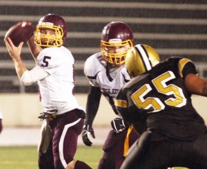 South Kitsap quarterback Tanner Romo looks for a receiver in the Wolves’ season-ending loss to Lincoln on Friday night in Tacoma.