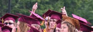 A Kingston High School senior points to family members during the graduation ceremony on Saturday.
