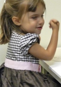 Emma Hall is animated while discussing a picture of a monkey. Her therapist was disguising teaching through play by asking questions about the monkey.