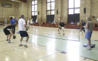 Glen Gray returns a serve in his doubles pickleball match in the fifth annual West Sound Senior Games Thursday.