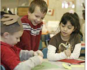 Crownhill Elementary School students Yumna Khuja (right) and Joey Roman (center) watch Alex Ledbelter construct a project. It’s back to school for Bremerton students beginning Wednesday.