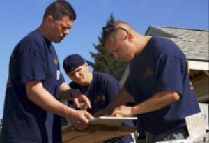 Volunteers assigned to Naval Base Kitsap measure wooden siding for a house during a Habitat for Humanity volunteer project Sept. 13. The Habitat for Humanity volunteer program is a non-profit organization that helps build housing in partnership with low-income families.
