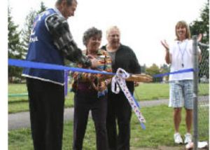 Bremerton School District Assistant Superintendent  Linda Jenkins (center) cuts the ribbon on the new Naval Avenue fitness park.