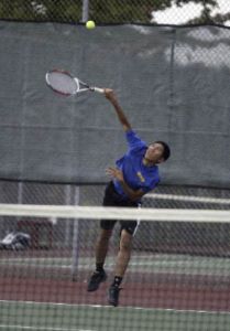 Bremerton junior Ahn Ho serves during Wednesday’s match against Port Angeles. Ho won in straight sets 6-3