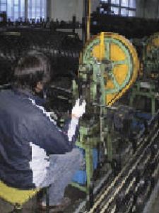 Silverdale Cyclery owner David Brumsickle visited bicycle factories in China in February. He watched as this worker at the Ace Trike bicycle factory in Shanghai