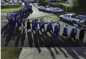 Olympic High School seniors make their way into the Kitsap County Fairgrounds Pavilion for graduation June 14.