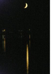 A golden crescent moon shines on the waters of Dyes Inlet in Silverdale. A golden crescent moon shines on the waters of Dyes Inlet in Silverdale.