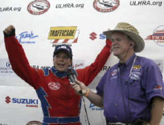 Kayleigh Perkins throws her arms up in celebration after claiming her second-straight win at Silverdale Thunder.