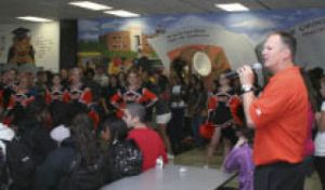 CK social studies teacher and former athletic director Mark Ward leads the pep rally Friday.