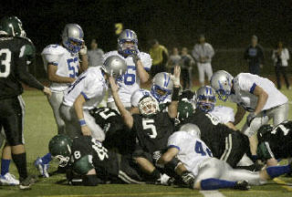 Klahowya’s Cody Hertenstein (5) signals touchdown after Sam Harris (48) scored on a run up the middle against Olympic on Sept. 12.