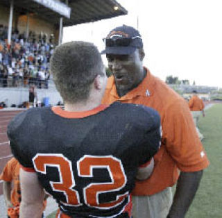 Central Kitsap coach Mark Keel and Coug Richie Meier celebrate on the sidelines. CK topped South 14-13.