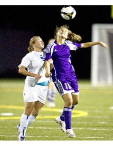 North Kitsap’s Siara Byers heads the ball away from Bainbridge’s Lauren Tyner
