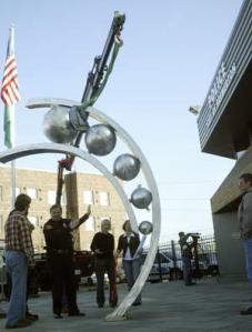 Bremerton Chief of Police Craig Rodgers instructs city workers where he would like the new art piece to be facing at the new station on Burwell.