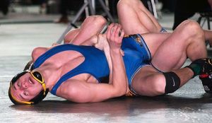 Bremeton’s Cameron Dubos struggles to break the hold of Orting’s Fred Green in the finals of the 138-pound Class 2A championships at Mat Classic XXVII in the Tacoma Dome.