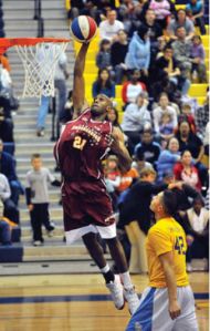 Harlem Ambassadors player Daytona Burch soars for a dunk during a fund-raising game in Texas. The Ambassadors will be in Bremerton Monday.