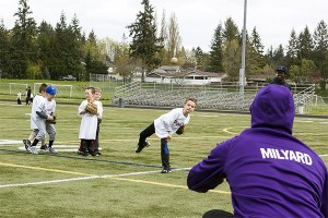 Senior North Kitsap varsity baseball player Kole Milyard catches for campers practicing their throwing skills at North Kitsap Stadium