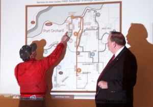 Kitsap Transit Service Development Director John Clauson helps a South Kitsap resident figure out where the revamped bus routes in the Port-Orchard area will serve.