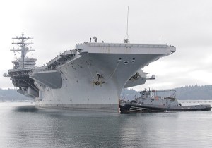 A tugboat helps dock the USS Nimitz at Pier Delta at the Puget Sound Naval Shipyard on Jan. 13.
