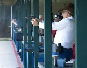 Robert Carpenter fires a handgun during the annual “Liberty Volley.'
