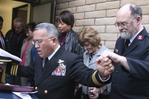 Navy Chaplain Cmdr. Manuel A. (Don) Biadog Jr. leads a dedication prayer for Sally’s Camp