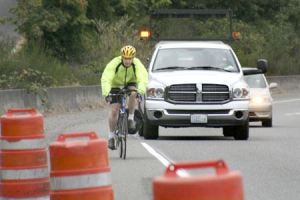 Dennis Pierce enters the Department of Transportation work zone on SR-3 accompanied by the project’s shadow vehicle Tuesday. Tuesday was the first day of the DOT using just one shadow vehicle at the project.