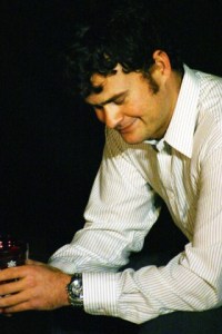 Bobby (Justin Carrell) thinks of his friends as he hears a message machine full of “happy birthdays