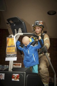 Ethan Goozovat and firefighter Jasper Stenstrom climb flights on a Stairmaster at Kingston Albertson’s. The event was a fundraiser for the Leukemia & Lymphoma Society.