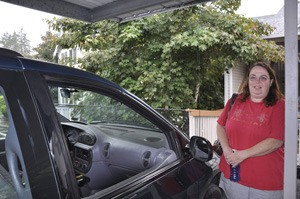 Kelly Kjostab stands by her Grand Caravan.