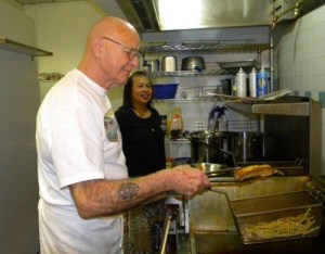 Rob Seever pulls a piece of cod out of the fryer