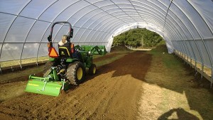 Maia Curry-Hughes tills the soil of the Giving Garden.