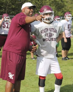 South Kitsap running backs coach Tony Reed gives junior Connor Seaton some pointers during practice Aug. 25.