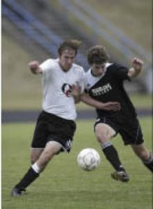 OC freshman Jereme Huesche battles a Highline defender during a 4-0 loss Wednesday.