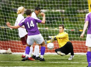 (Top photo) All-star goalie Devin Langaker puts the stop on a Seahawk goal. (Middle photo) This is how the Bucs celebrate winning a state playoff game. (Bottom