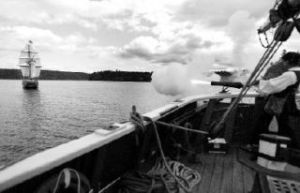 (above) Lady Washington gunner Roscoe Washcher fires off one of the guns located on the Lady Washington at the Hawaiian Chieftain. (right) Mate in training Margart Strozyll steers the Lady Washington by adjusting the sails.