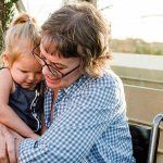 Karen Fletcher, 61, hugs her 2-year-old granddaughter at a party held in her honor at the Grand Legacy Hotel in California.                                Kelly Sweda Photography / Dream Foundation