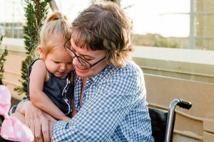 Karen Fletcher, 61, hugs her 2-year-old granddaughter at a party held in her honor at the Grand Legacy Hotel in California.                                Kelly Sweda Photography / Dream Foundation