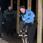 Bremerton Police K-9 Officer Bryan Hall rewards his dog, Ando, after successfully tracking down a decoy during a training hunt. Michelle Beahm / Kitsap News Group