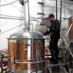 Worker at Rainy Daze Brewery in Poulsbo checks the tank in preparation for final hopping. (Terryl Asla/Kitsap News Group)
