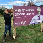 Marcel Imbach, cofounder of Vibe Coworks, posts a sign announcing the project&rsquo;s upcoming construction. (Contributed photo)