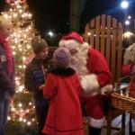 Santa Claus visits with children during the Julefest celebration, Dec. 3 at Muriel Iverson Williams Waterfront Park. (Angie Donovan/Kitsap News Group correspondent)