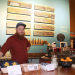 Jesse Wilson works the Lovecraft bar during the busy anniversary celebration Nov. 26. Wilson and his wife, Tasha, opened their brewery Nov. 27, 2015.                                Michelle Beahm / Kitsap News Group