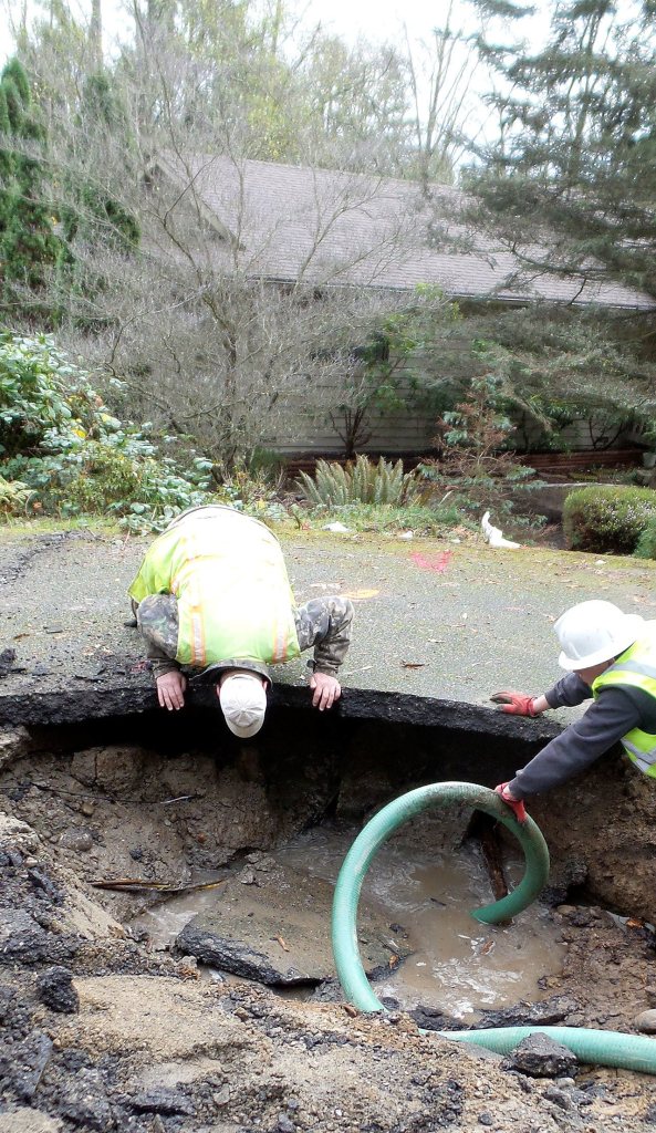 A water main break on Nov. 18 resulted in about 600,000 gallons of water being lost from various Silverdale Water District reservoirs. The water washed out the road bed at the site of the break, causing two sink holes within 200 feet of each other.                                Sid Williams / Silverdale Water District